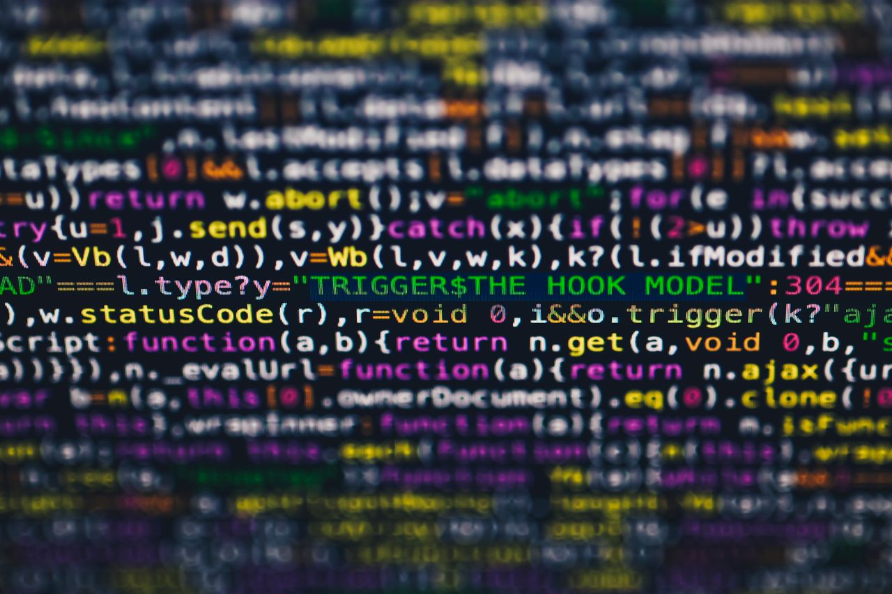 why-choose-us Vibrant close-up of multicolor programming code lines displayed on a screen.