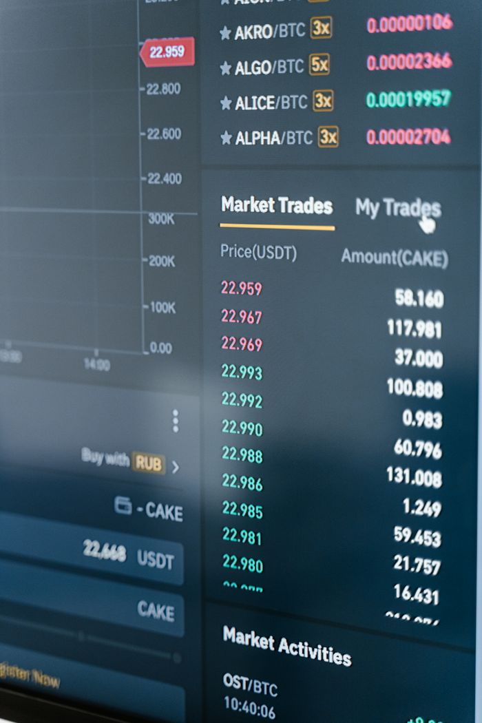 hero-img-01 Close-up of a cryptocurrency trading screen showing market trades and activities.
